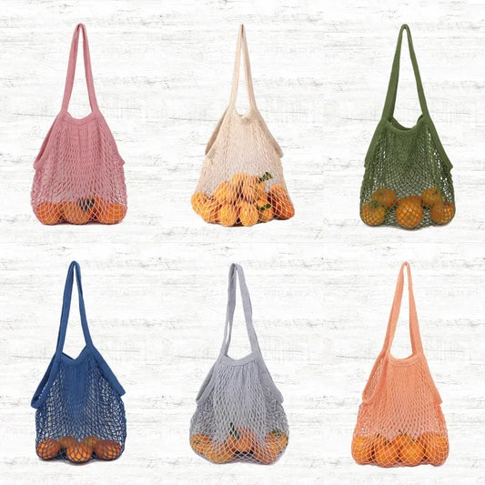 Front view of Six colorful cotton net shopper bags,  oranges,  pink, beige, green, blue, grey.