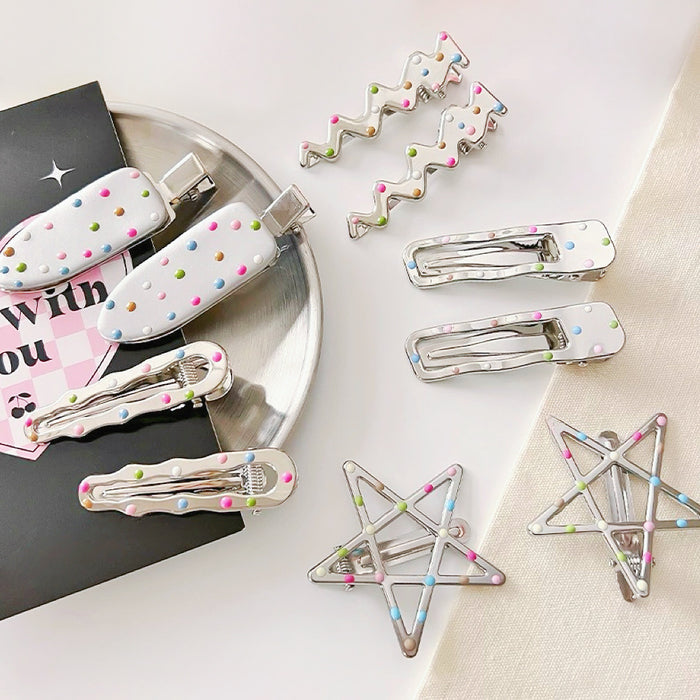 Front view of Silver alloy hair clips with colorful polka dots in various shapes: wave, arrow, and star.