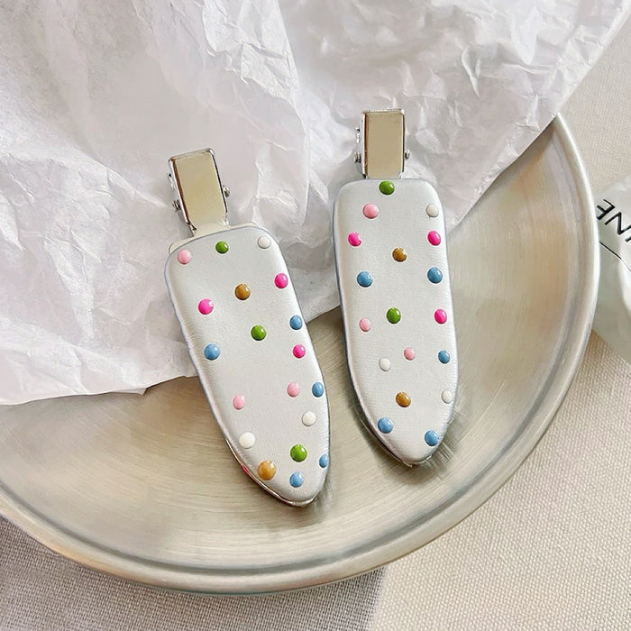 Close-up of Colorful Polka Dot Hair Clip in arrow shape , easy for workdays and special occasions.