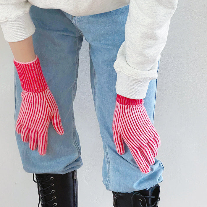 Close-up contrast striped knit gloves with ribbed cuff; cozy warmth for cold-day outfits.