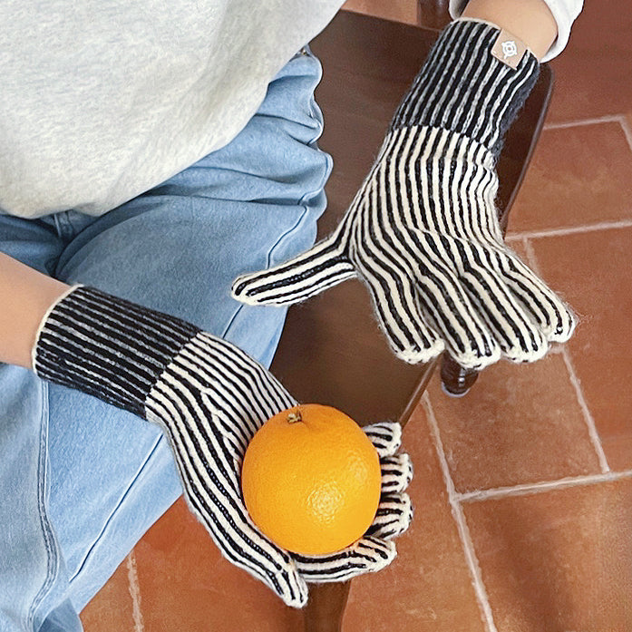 Flat lay contrast striped knit gloves with bold band detail; warm knit for chilly days.