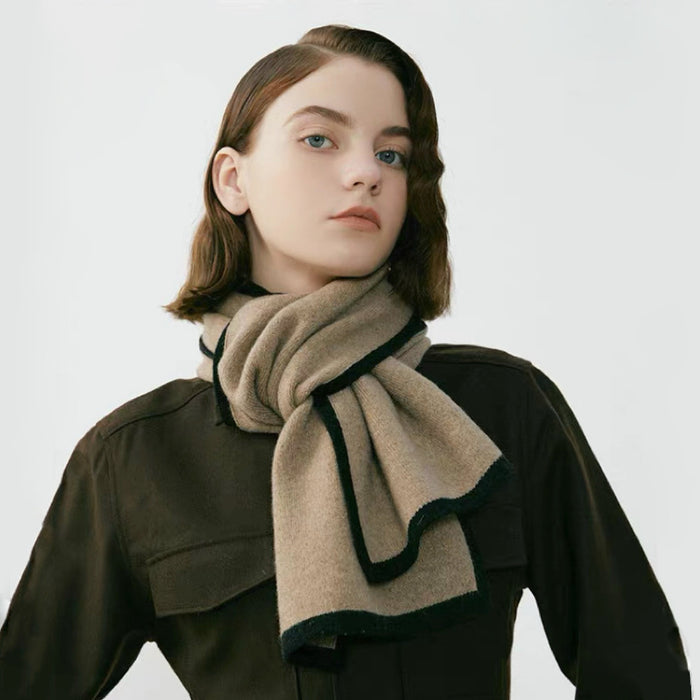 Model wearing a beige wool-polyester knit scarf with black contrast trim, tied around the neck in gray, great.