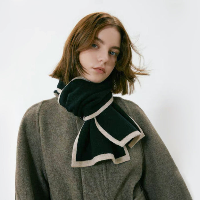 Model wearing a wool knit scarf in black, easy for weekend styling and gifting.