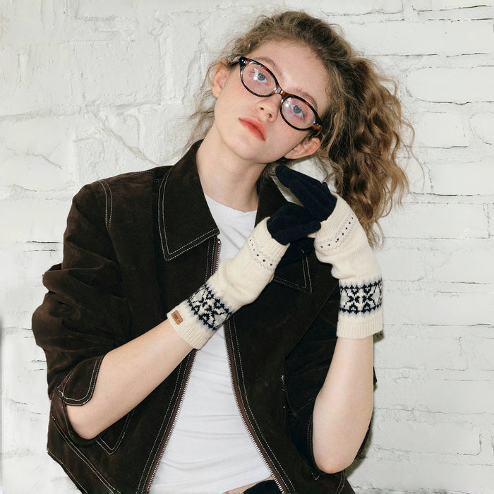 Flat lay convertible Fair Isle knit gloves, cream cuffs over dark gloves; patterned knit for cold days.