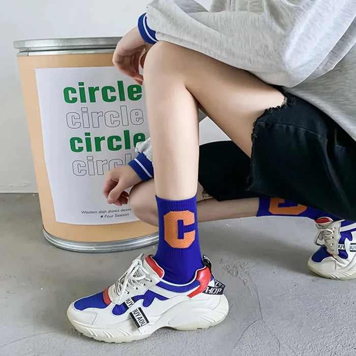 Model wearing a pair of Cool C Socks in blue, easy to pack for travel and errands.
