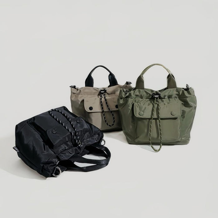 Display showing the utility bag in green, khaki, and black colors.