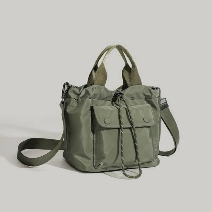 Frontal view of the olive green cube-shaped utility bag.