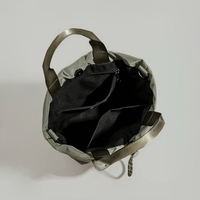Interior view showing the spacious storage compartments of the utility bag.
