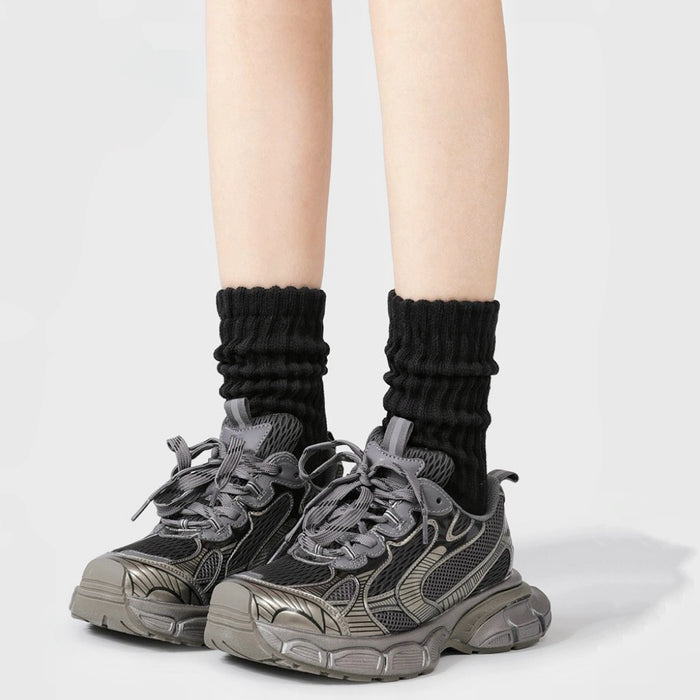 Model wearing a pair of  Cotton Slouch Socks in black, easy to pack for travel and errands.
