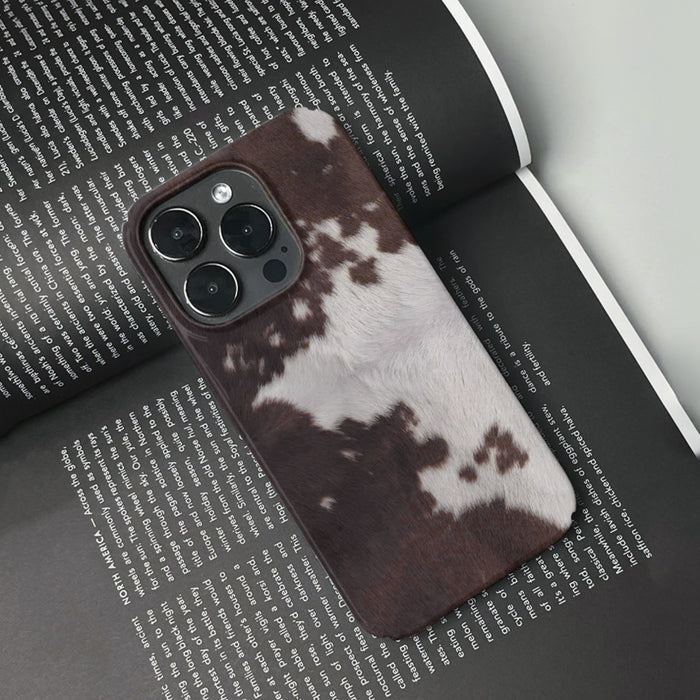 Front view of Cowhide Pattern Case. Classic cowhide motif on durable silicone and faux-leather construction.
