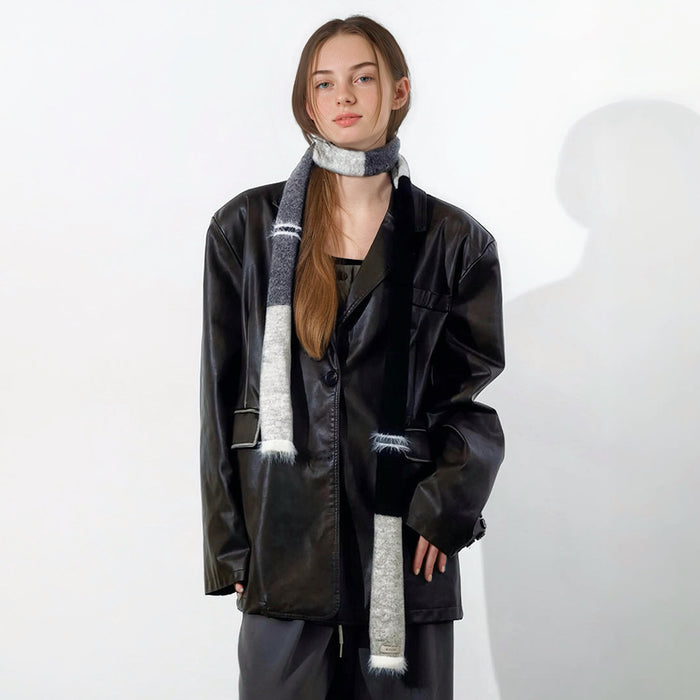 Model wearing a wool scarf in black and gray, easy for weekend styling and gifting.