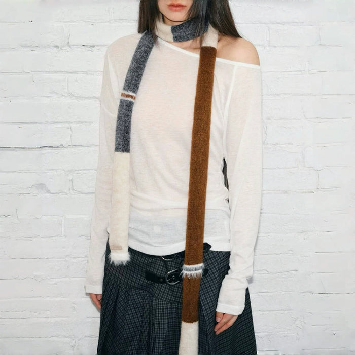 Model wearing a wool scarf in beige and brown, great for office layering and commuting.