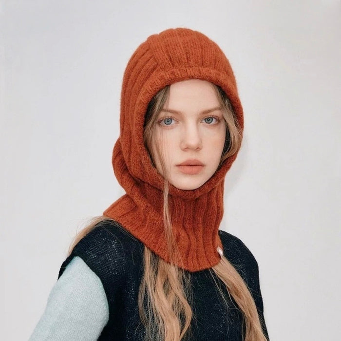 Model wearing rust orange ribbed knit balaclava hat, a cozy winter essential for outdoor warmth.