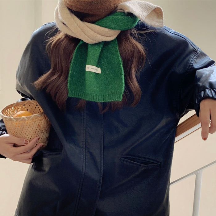 Model wearing a wool scarf in khaki and green, easy for weekend styling and gifting.