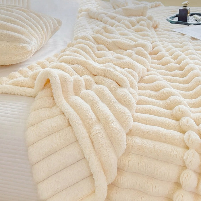 Cream white fleece blanket with wave texture shown flat on bed, cozy home decor