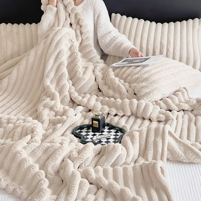 Light khaki wave textured fleece blanket spread on bed, vibrant seasonal home accessory.