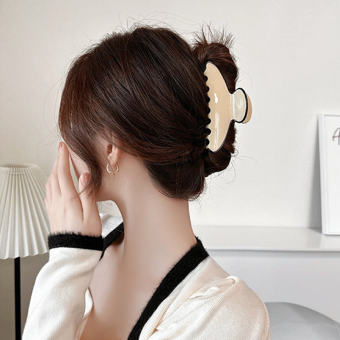 Model wearing Cream Black Border Hair Claw in curve shape, easy for workdays and special occasions.