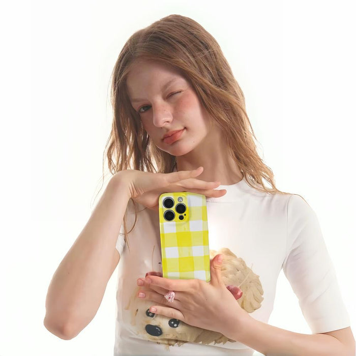Model holding Cream Yellow Checker Case. Smooth durable acrylic in a classic retro-inspired pattern.