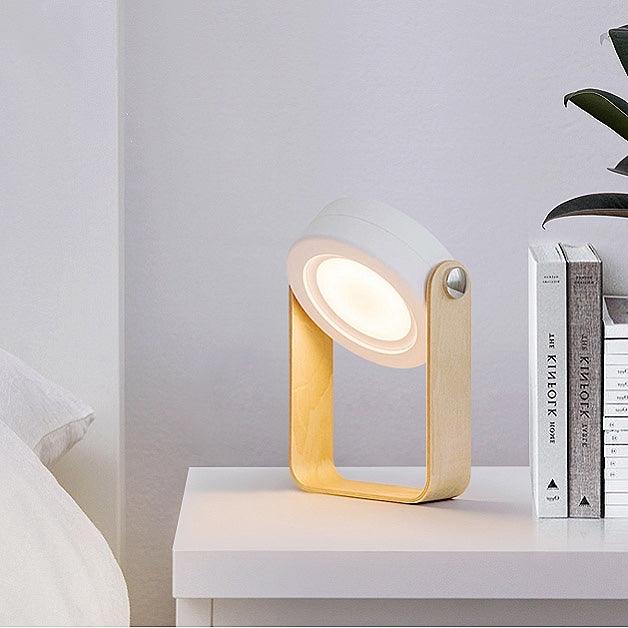 White and wood Creative Lantern Lamp, retracted as a searchlight, on a white nightstand.