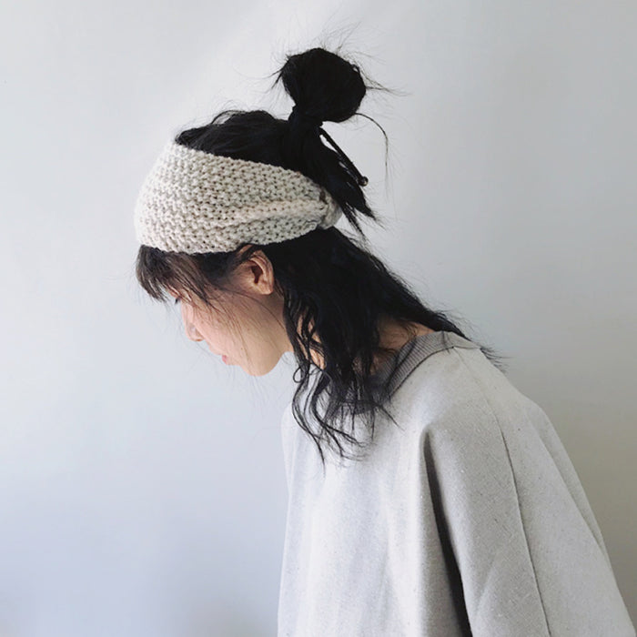 Model wearing a  Crochect Bow Headband in white, ideal for everyday outfits and office looks.