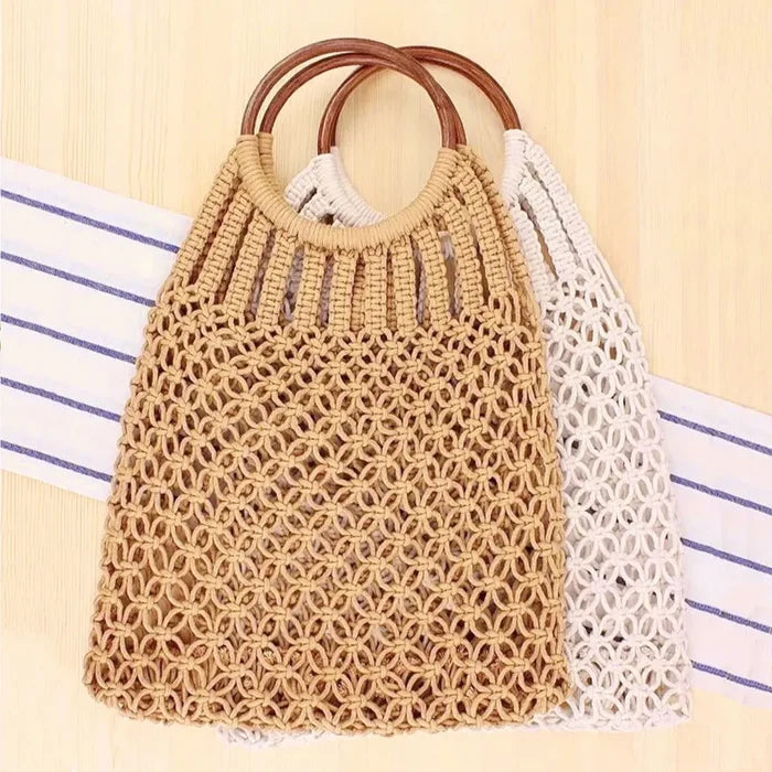 Front view of Two crochet cotton handbags with wooden ring handles, one in natural beige and one in off-white.