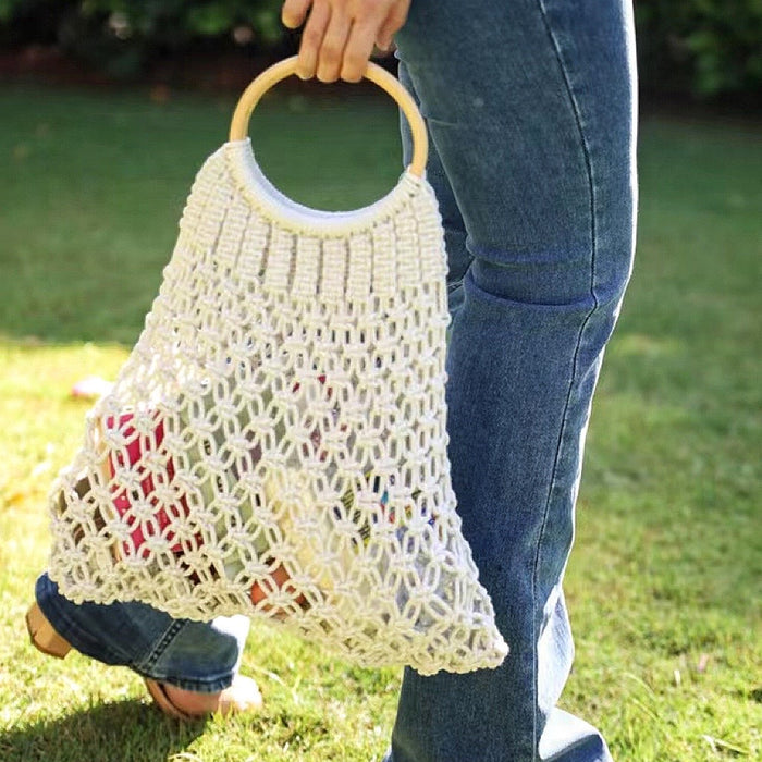 Model holding a Crochet Handbag With Wooden Ring in white, ideal for errands and gifting.