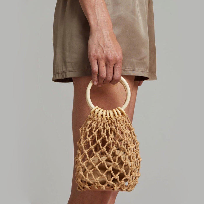 Model carrying a Crochet Mini Handbag With Wooden Ring handheld , great for daily carry and travel.