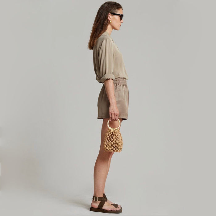 Model carrying a white Crochet Mini Handbag With Wooden Ring handbag , great for daily carry and travel.