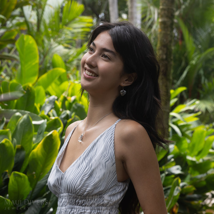 Woman in a tropical garden wearing a Crystal Pineapple Pendant in Sterling Silver