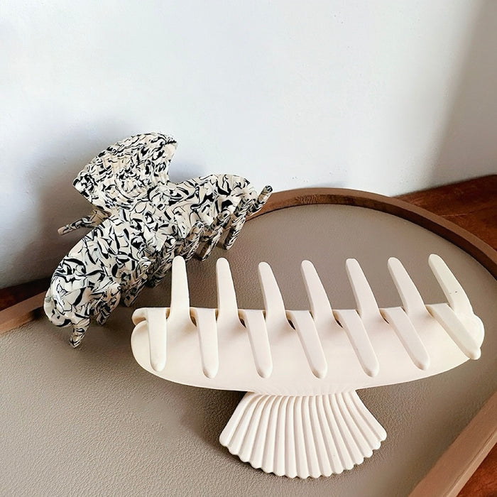 Angled view of Shell Hair Claw hair claw clip in ivory hair accessory and camel hair accessory, ideal for quick updos.
