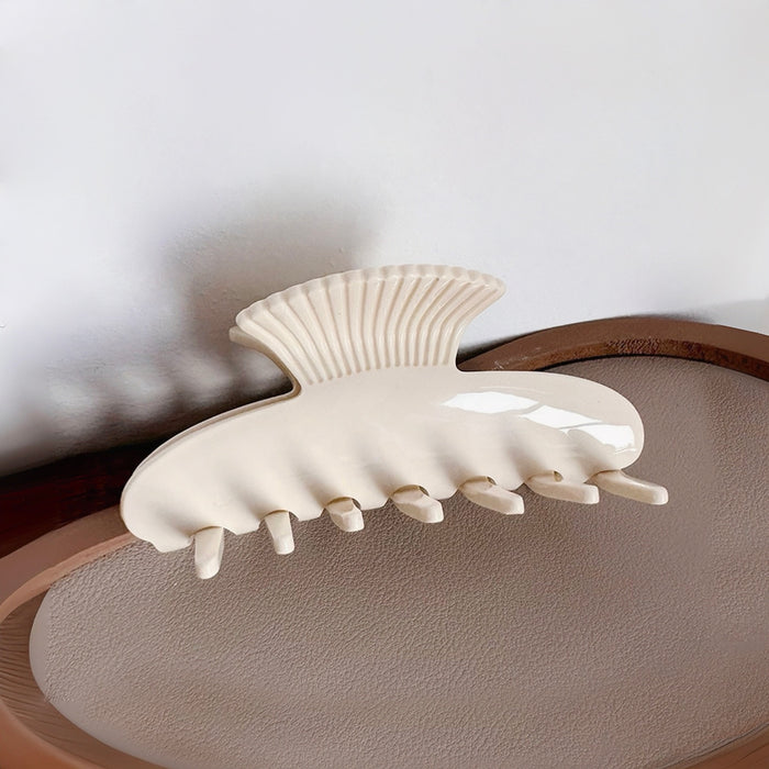 Flat lay of Shell Hair Claw hair claw clip in white, great for everyday styling and gifting.