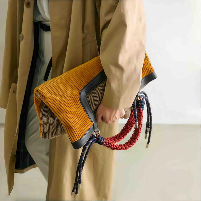 Gentle Beam tote folded into a stylish clutch bag, highlighting the textured tweed back and versatile multi-functional design.