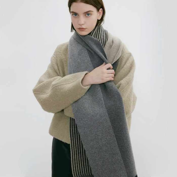 Model wearing a striped scarf in gray and beige, easy for weekend styling and gifting.