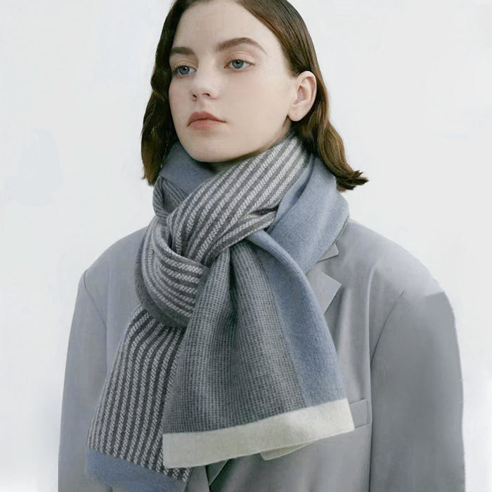 Model wearing a striped scarf in gray and blue, ideal for daily wear and travel.