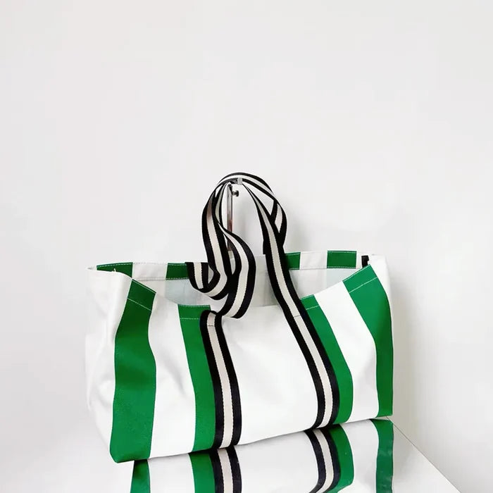 Large canvas tote bag with vibrant green and white vertical stripes.