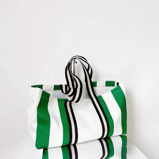 Large canvas tote bag with vibrant green and white vertical stripes.