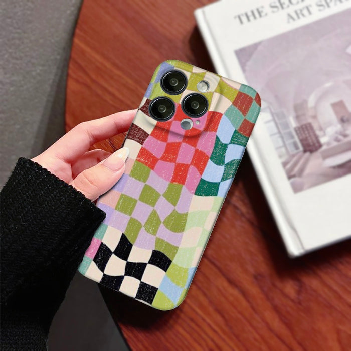 Handheld view of the distressed colorful checkerboard phone case, perfect for streetwear style.