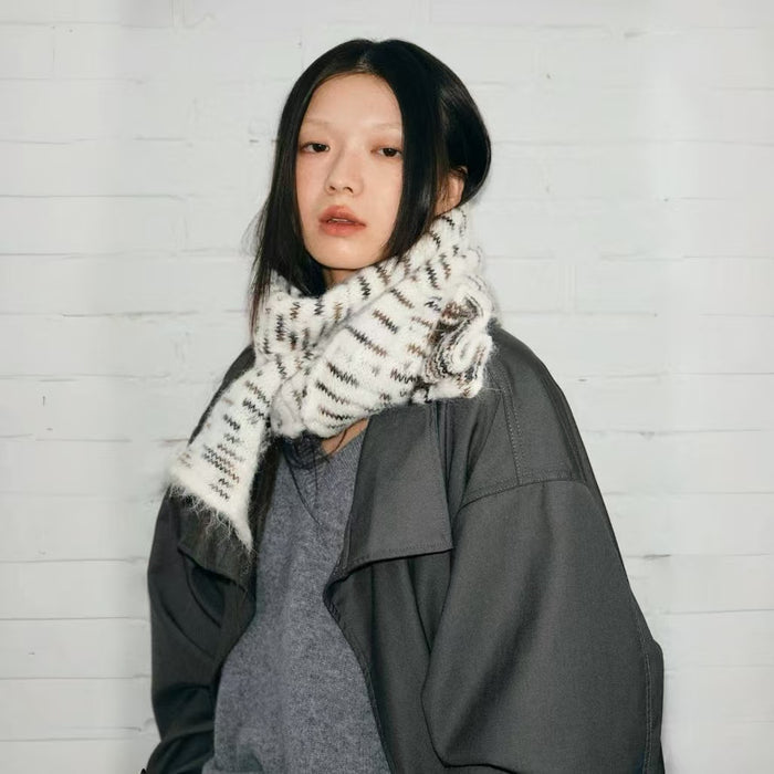Model wearing soft, dual-sided wool blend scarf in white with brown and black aurora texture in gray, ideal for daily.