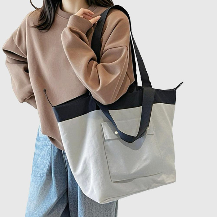 Model carrying a gray nylon tote bag on the shoulder, great for daily carry and travel.
