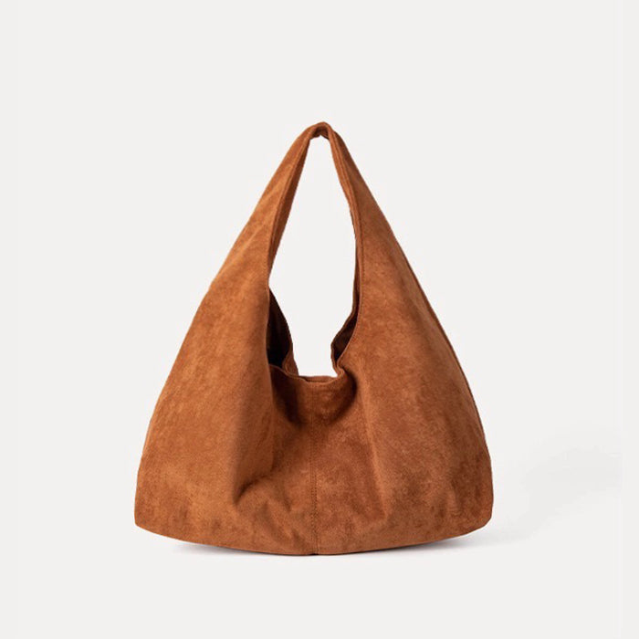 Soft-touch warm tan ease suede hobo bag with a foldable design.