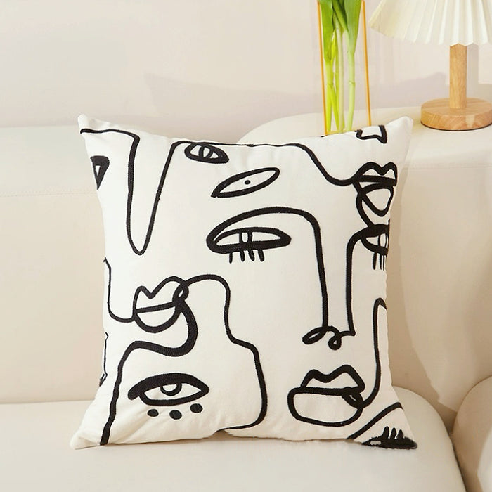 Close-up of Elegant Vibe Pillow Cover with abstract face pattern.