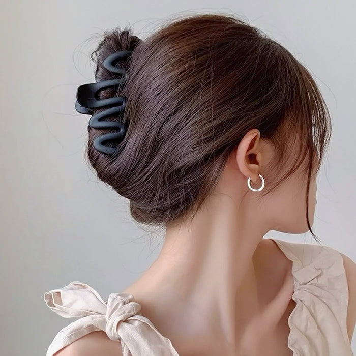 Model wearing Elegant Wave Hair Claw  in black, great for everyday styling and gifting.