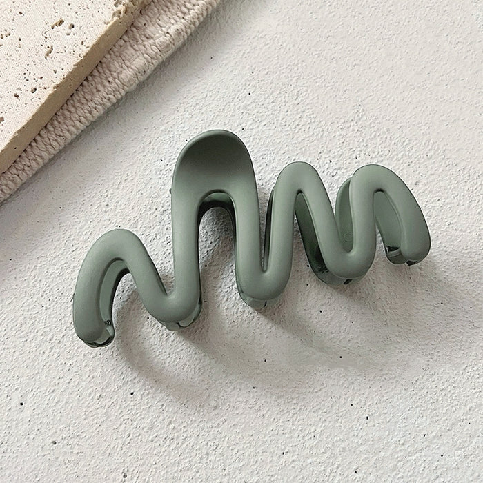 Folded view of Elegant Wave Hair Claw  in green, ideal for quick updos and ponytails.