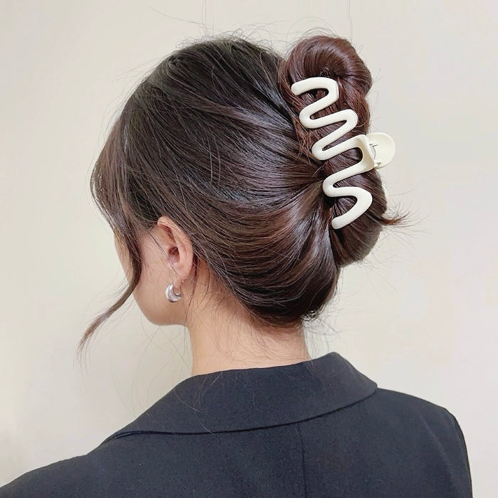 Model wearing Elegant Wave Hair Claw  in cream, easy for workdays and special occasions.