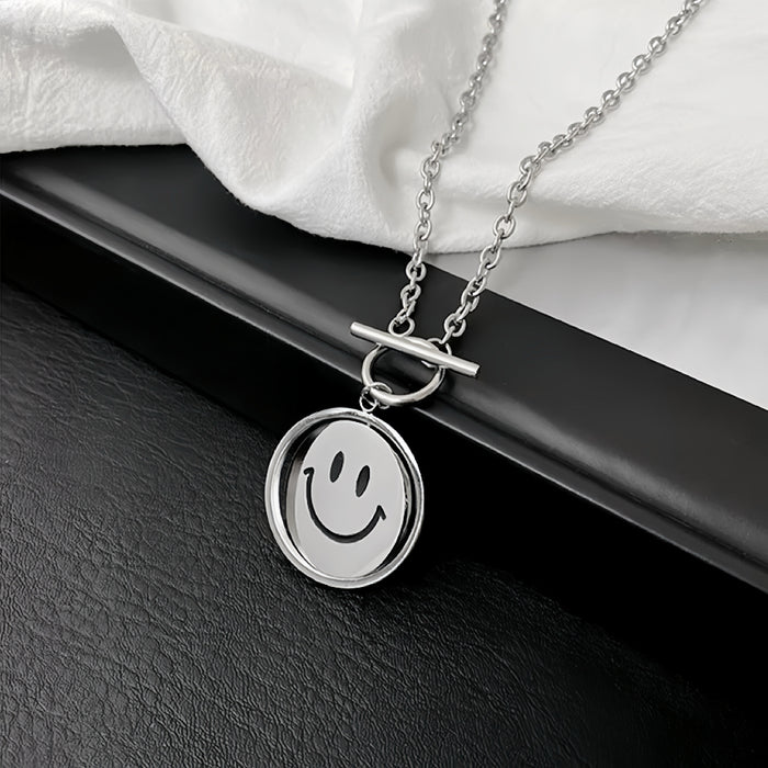 Flat lay of silver titanium steel emoti spin necklace on a dark surface