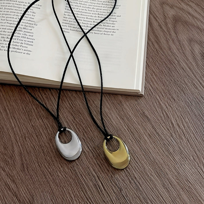 Front view of gold and silver Eon Circle Pendant Necklaces show together.