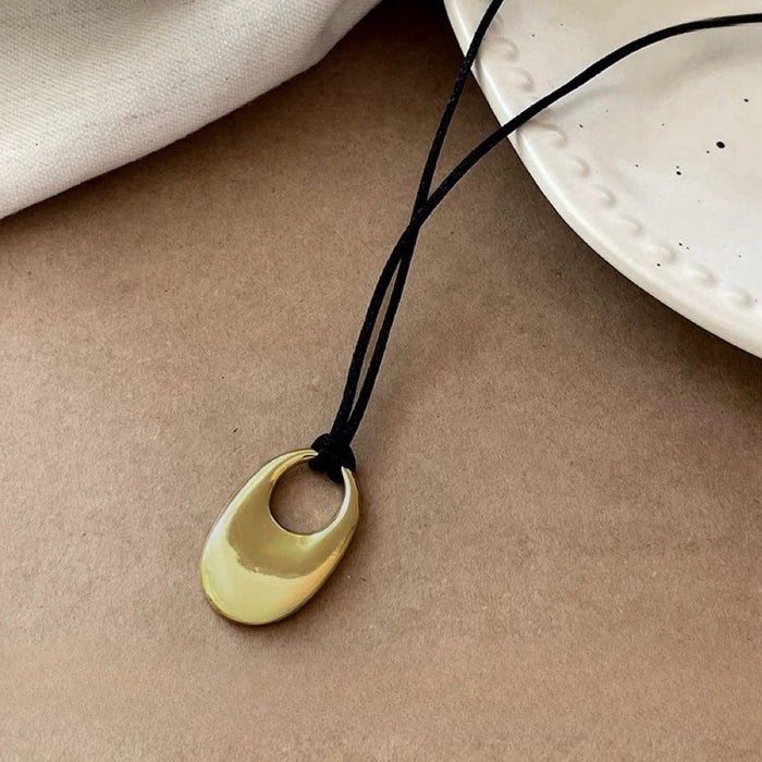 Close-up of Eon Circle Pendant Necklace in Gold, easy to style for workdays.