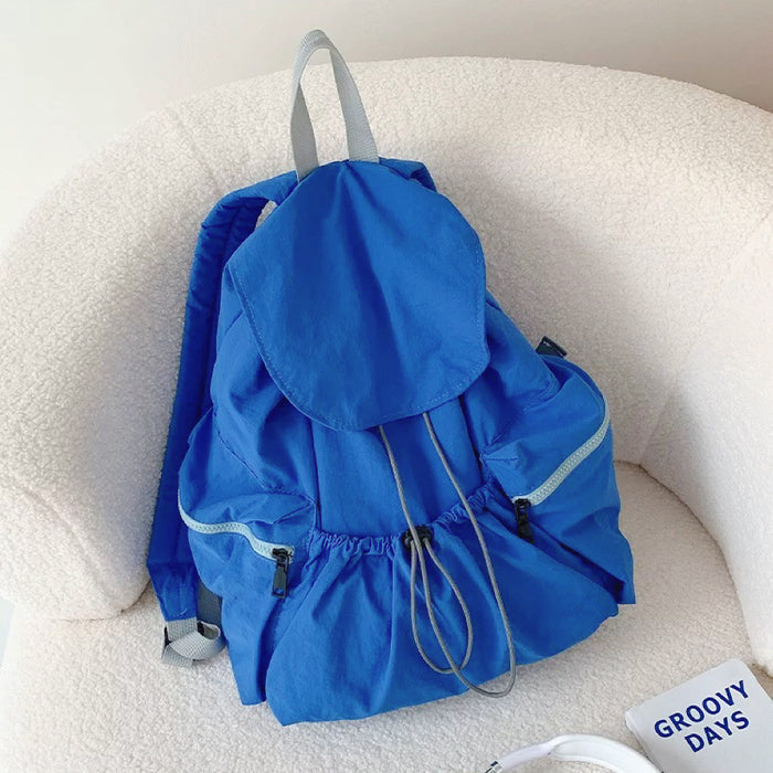 Bright blue ultralight nylon backpack with drawstring closure; lightweight design for vibrant urban mobility.