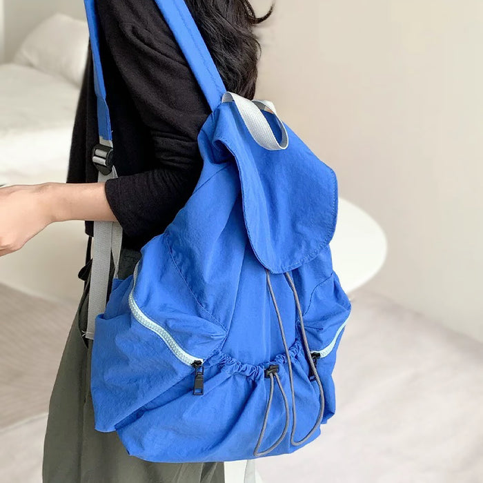 Model wearing the blue ultralight backpack; sleek profile perfect for daily essentials and social outings.