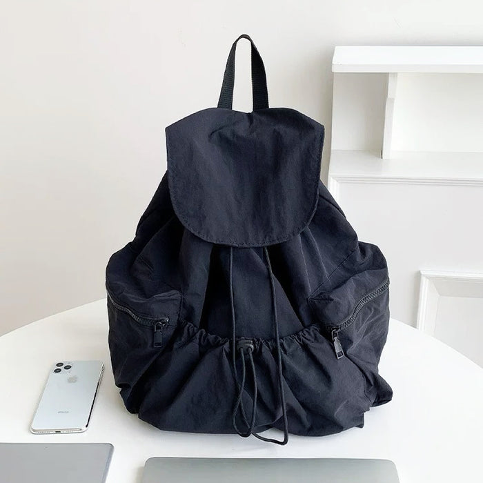 Classic black ultralight backpack; minimalist aesthetic suited for professional work environments and laptop carry.